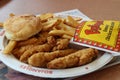 Fried chicken tenders, french fries, and a buttermilk biscuit at a BojanglesÃ¢â¬â¢ restaurant. Royalty Free Stock Photo