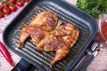 Fried chicken tobacco tabaka in a grill pan.