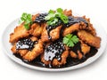 fried chicken with vegetables and black sauce on plate on white background