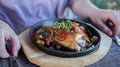 Fried chicken with vegetables. The lunch process. The knife cuts the dish. Royalty Free Stock Photo