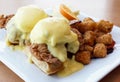 Fried chicken and waffles with eggs benedict on top