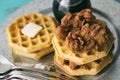 Chicken and waffles with maple syrup and butter. Shown with silverware on a galvanized tray. Royalty Free Stock Photo