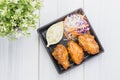 Fried chicken wing and salad on tablecloth on white wood table in kitchen,food menu appetizer