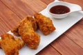 Fried chicken wings with barbeque sauce. Breaded Crispy fried chicken on wooden table. Deep fried food. Royalty Free Stock Photo