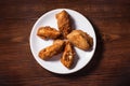Fried chicken wings in batter on white plate over wooden background.. Spicy Deep Fried Breaded Chicken Wings with Ranch
