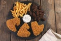 Fried chicken wings breaded crispy with french fries fried rye bread croutons beer snack Royalty Free Stock Photo