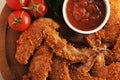 Fried chicken wings breaded with ketchup, tomato and parsley Royalty Free Stock Photo