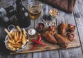 Fried chicken wings, french fries, nuts, white and red sauce. Beer set Royalty Free Stock Photo