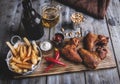 Fried chicken wings, french fries, nuts, white and red sauce. Beer set Royalty Free Stock Photo