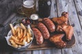 Fried chicken wings,grilled sausages, french fries, nuts, white and red sauce. food to beer Royalty Free Stock Photo