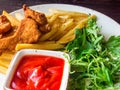 Fried chicken wings and legs with french fries on wooden table. Breaded Crispy fried kentucky chicken tasty dinner with fried Royalty Free Stock Photo