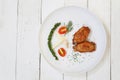 Fried Chicken wings with pepper in white dish on wooden floor Royalty Free Stock Photo