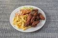 Fried chicken wings with salad and tomato and french fries served Royalty Free Stock Photo