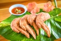 Fried chicken wings served on leaves with sauce top view - crispy chicken wings on wooden table , Thai Food Asian