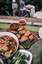 Fried Chicken Wings with Thai spicy sauce in white dish on wooden table top. Royalty Free Stock Photo