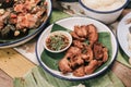 Fried Chicken Wings with Thai spicy sauce in white dish on wooden table top. Royalty Free Stock Photo