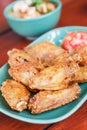 Fried chicken wings on a wooden table. Thai Food.