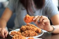 Fried chicken in young woman hand select focus, Hand with fried chicken blur background, Close-up Fried chicken. Royalty Free Stock Photo