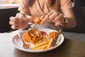 Fried chicken in young woman hand select focus, Hand with fried chicken blur background, Close-up Fried chicken. Royalty Free Stock Photo