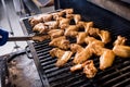 Fried chiken wings at grill barbecue. Restaurant. Royalty Free Stock Photo