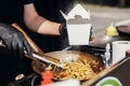 Fried chinese japanese noodles with vegetables and shrimps in takeaway box.Food delivery. Chef putting noodles in carton box to go Royalty Free Stock Photo