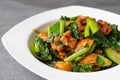 Fried Chinese kale with crispy skin chicken in oyster sauce and chilli in the white dish Royalty Free Stock Photo