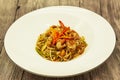 Fried Chinese noodles with vegetables and a cauliflower and with seafood. Royalty Free Stock Photo