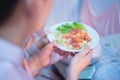 Fried Chinese sausage rice in the hands of an Asian man