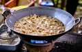 Fried chips in oil at wok. Asian, Indian and Chinese street food