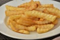 Fried chips on a plate. French fries in a white plate