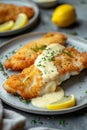 fried cod fillet with cream sauce and lemon Royalty Free Stock Photo