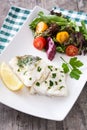 Fried cod fillet and salad in plate Royalty Free Stock Photo