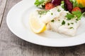 Fried cod fillet and salad in plate Royalty Free Stock Photo