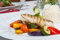 Fried cod with roasted vegetables. Royalty Free Stock Photo
