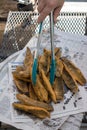 Fried cornmeal coated fish fillets stacked on newspaper Royalty Free Stock Photo