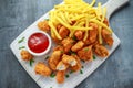 Fried crispy chicken nuggets with french fries and ketchup on white board Royalty Free Stock Photo