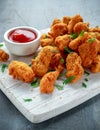 Fried crispy chicken nuggets with ketchup on white board Royalty Free Stock Photo