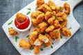 Fried crispy chicken nuggets with ketchup on white board Royalty Free Stock Photo