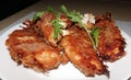 Fried crispy chicken nuggets on a plate with greens closeup Royalty Free Stock Photo