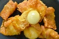 Fried crispy Chinese dumpling paste wrapped egg quail on plate