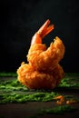 fried crispy shrimp on a wooden table with wasabi on a dark background