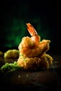 fried crispy shrimp on a wooden table with wasabi on a dark background