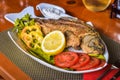 Fried crucian carp fish on a decorated plate