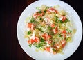 Fried crunchy rice noodles with salmon ceviche, scallions and sesame seeds