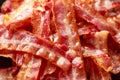 Fried crunchy Streaky Bacon pieces in a black plate Royalty Free Stock Photo