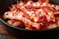 Fried crunchy Streaky Bacon pieces in a cast iron skillet Royalty Free Stock Photo