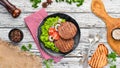 Fried cutlet for burger with vegetables. In a black plate on a wooden background Top view. Free space for your text. Flat lay Royalty Free Stock Photo