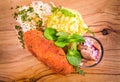 Fried cutlet, mashed potatoes, sauerkraut and pickled mushrooms on a wooden board Royalty Free Stock Photo