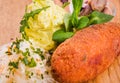 Fried cutlet, mashed potatoes, sauerkraut and pickled mushrooms on a wooden board Royalty Free Stock Photo