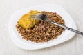 Fried cutlet of turkey meat with buckwheat, fork in plate Royalty Free Stock Photo